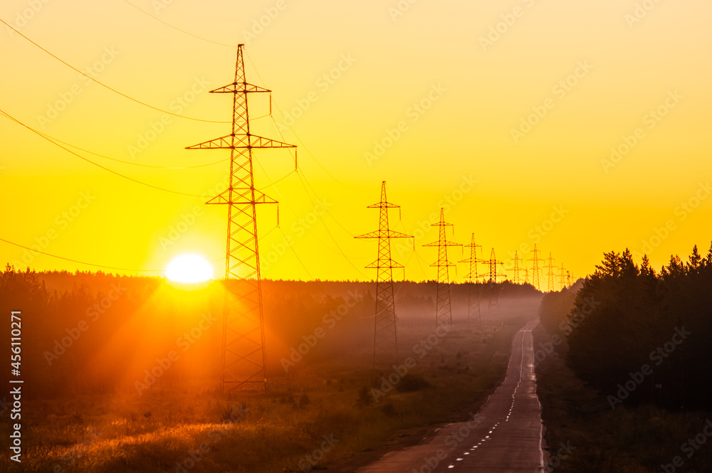 power lines at sunrise along the road