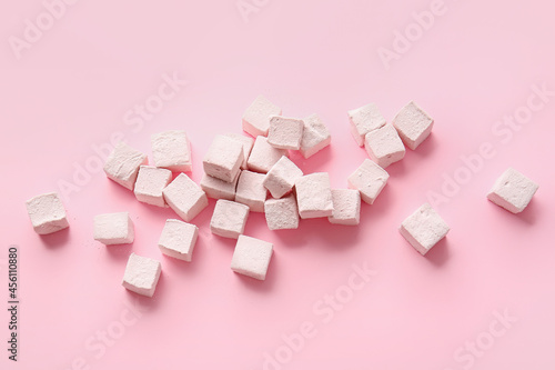 Tasty sweet marshmallows on color background