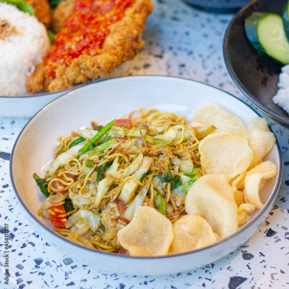 Indonesian vegetarian noodles and prawn crackers Indonesian vegetarian noodles and prawn crackers