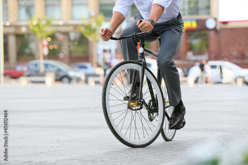 Businessman going to work by bicycle on city street © Pixel-Shot