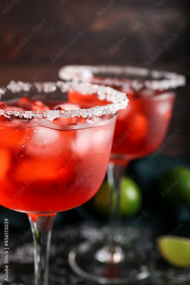Glasses of tasty cosmopolitan cocktail on dark background, closeup Glasses of tasty cosmopolitan cocktail on dark background, closeup
