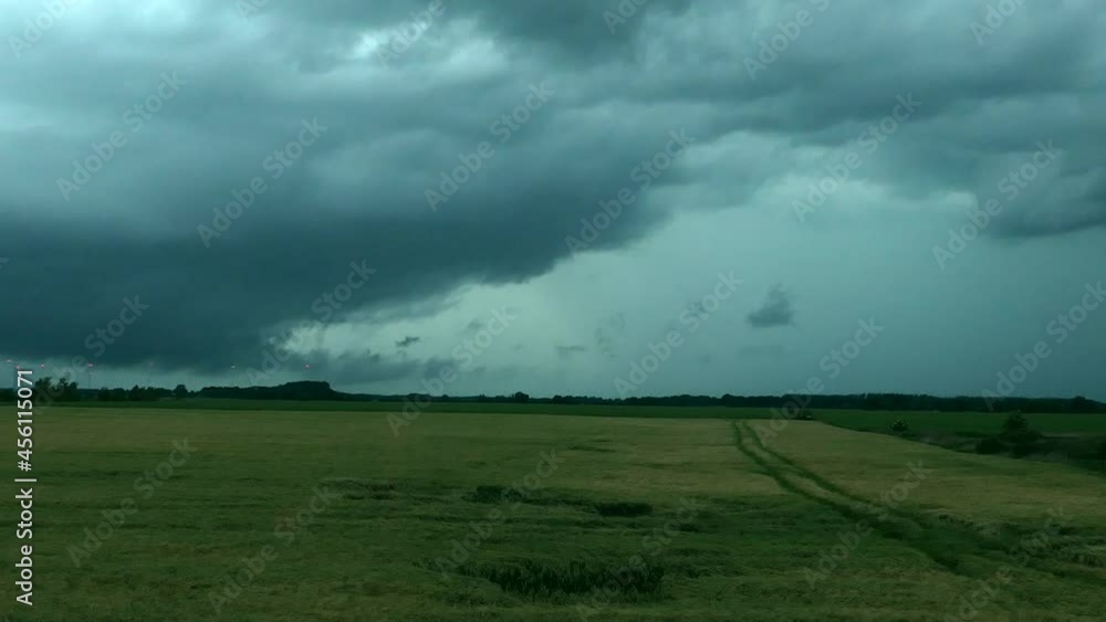 Dark storm clouds roll over a field. Dark storm clouds roll over a field.