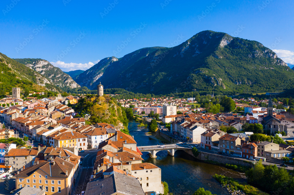 View from drone of small French town of Tarascon-sur-Ariege on banks of Ariege river in valley of Pyrenees 