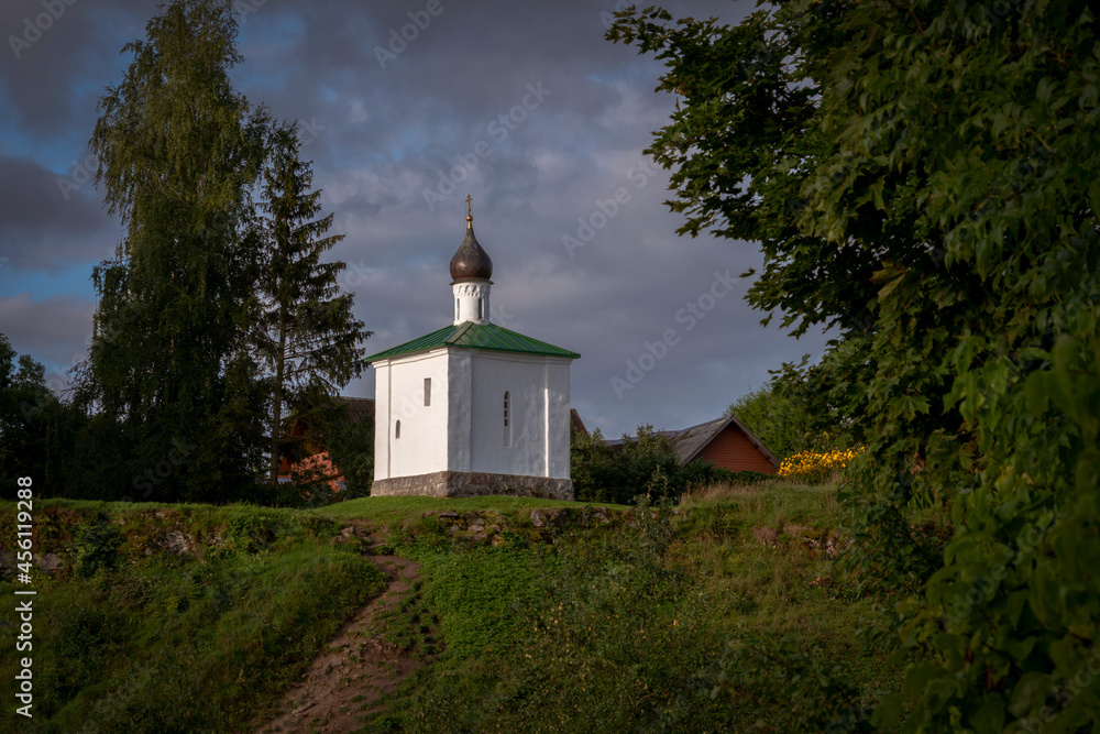 View of the Chapel of the Korsunskaya Icon of the Mother of God on a sunny summer evening with clouds, Izborsk, Pskov region, Russia