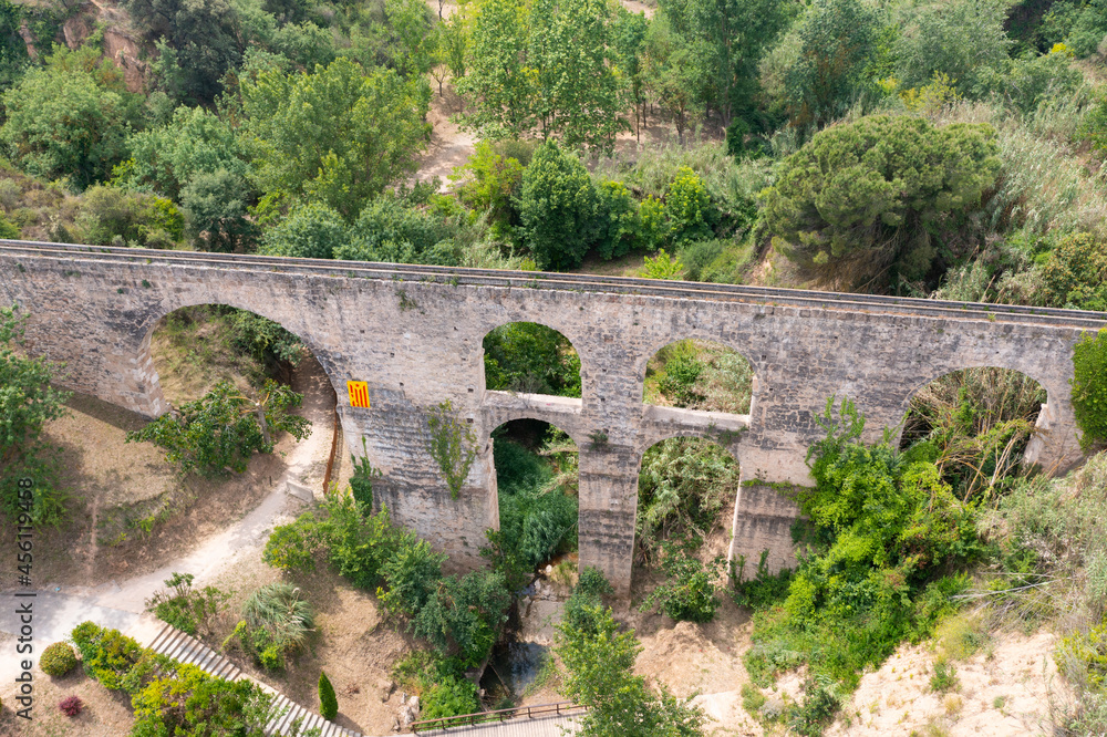 Aerial view of ancient Roman aqueduct near small Spanish township of Sant Pere de Riudebitlles in Catalonia on sunny summer day