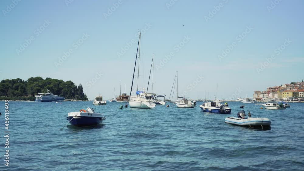 Boats from different sizes bobbing peacefully in a small harbour beside the coast. Boats from different sizes bobbing peacefully in a small harbour beside the coast.