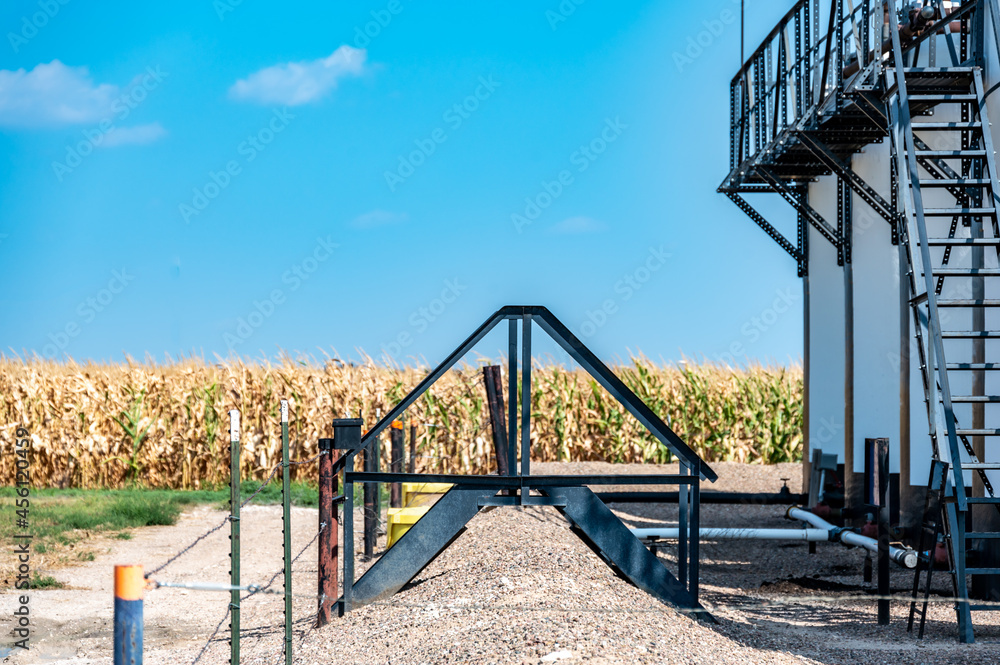 Ramp and stairs over a secondary containment dike for chemical oil storage confined space Ramp and stairs over a secondary containment dike for chemical oil storage confined space