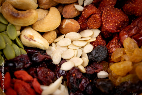 Closeup group of various types of whole grains and dried fruits.