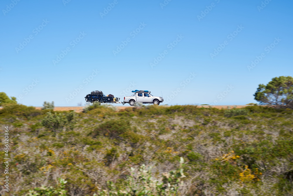 Ute towing a camper trailer on a road trip in coastal Western Australia