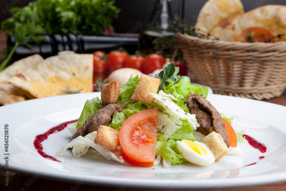 salad with pieces of pork, herbs, raspberry sauce and egg
salad with pieces of pork, herbs, raspberry sauce and egg