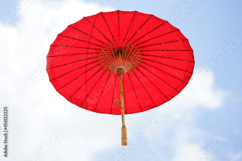 Red umbrellas on the sky background. Decorated with umbrella hanging.
