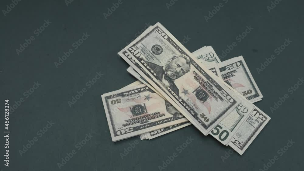 50 dollar bills being dropped on table. High quality 4k footage 50 dollar bills being dropped on table. High quality 4k footage