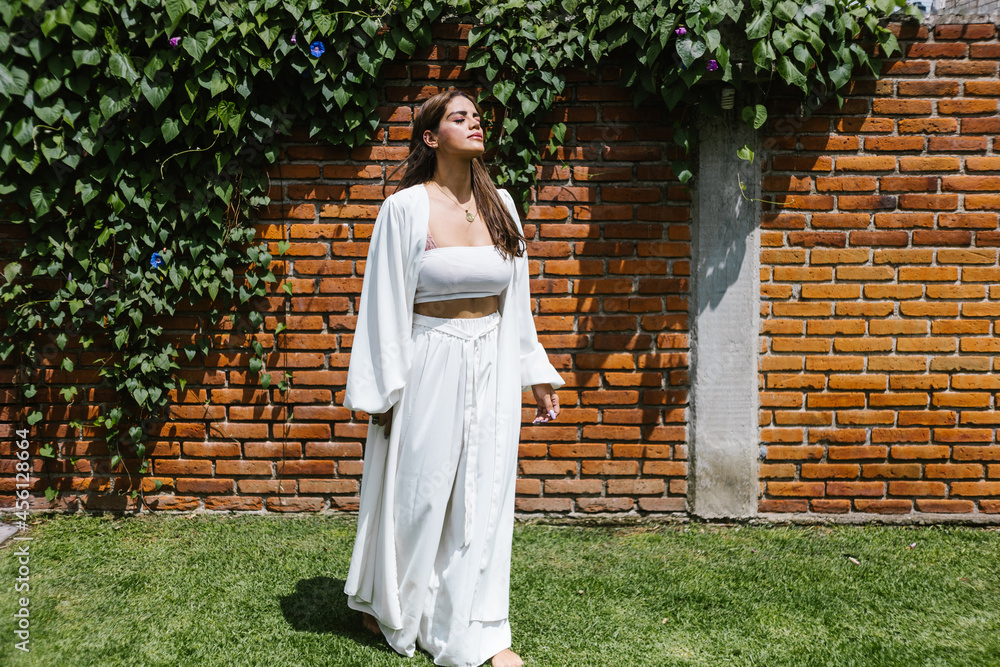 latin holistic therapist woman breathing calmly standing in the garden in Latin America latin holistic therapist woman breathing calmly standing in the garden in Latin America