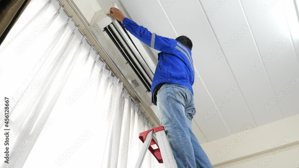 Maintenance man to check and cleaning air condition in the room Maintenance man to check and cleaning air condition in the room