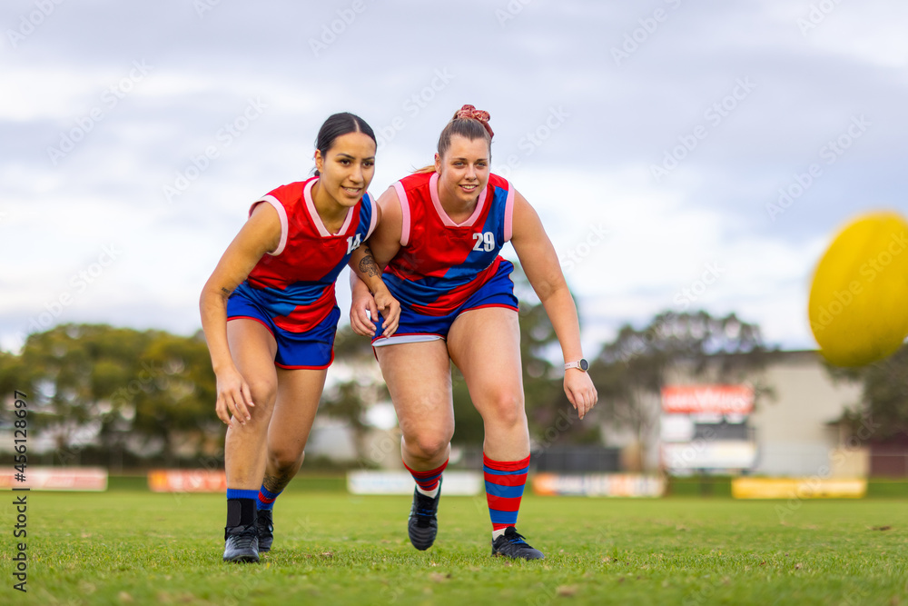 two female footballers approaching with eyes on the ball two female footballers approaching with eyes on the ball