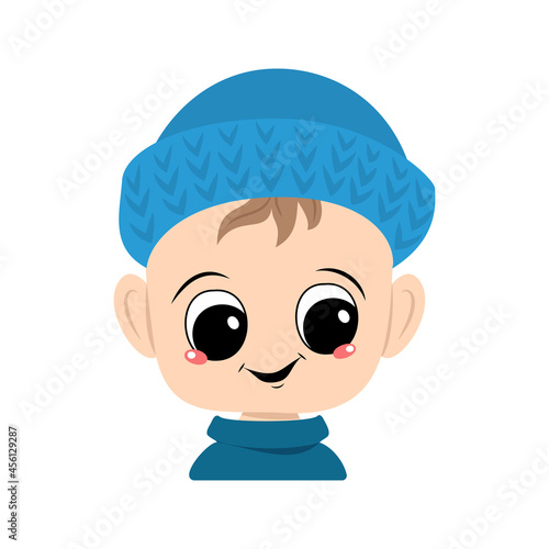 Avatar of a child with big eyes and a wide smile in a blue knitted hat. A cute kid with a joyful face in an autumnal or winter headdress. Head of adorable toddler with happy emotions