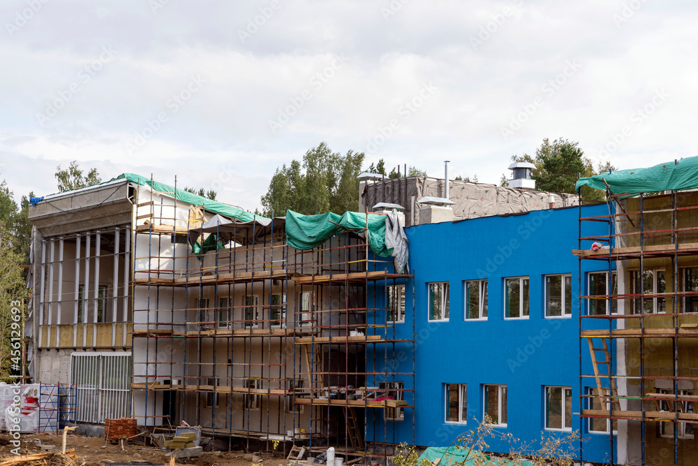 The progress of the construction of the kindergarten building. Colorful cheerful modern decoration of building facades