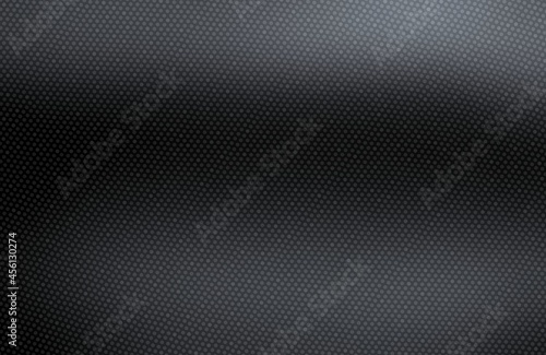 Black textured background covered dots grid pattern. Dark smooth surface metal effect.