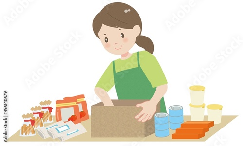 食料を箱に詰める作業をする女性 