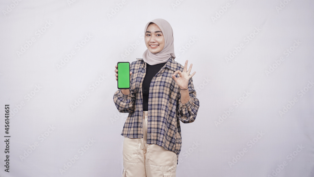 beautiful asian woman showing smartphone screen gesturing okay isolated on white background beautiful asian woman showing smartphone screen gesturing okay isolated on white background