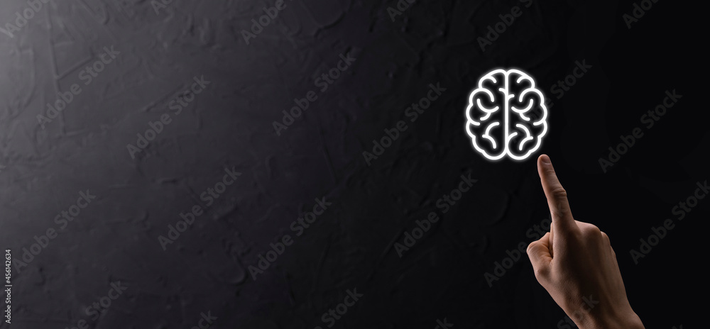 Male hand holding brain icon on blue background. Artificial intelligence Machine Learning Business Internet Technology Concept.Banner with copy space Male hand holding brain icon on blue background. Artificial intelligence Machine Learning Business Internet Technology Concept.Banner with copy space