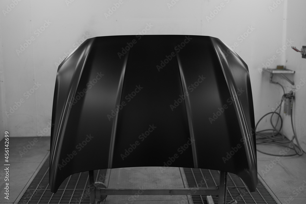 Car maintenance station. Car repair. The painted hood of the car is