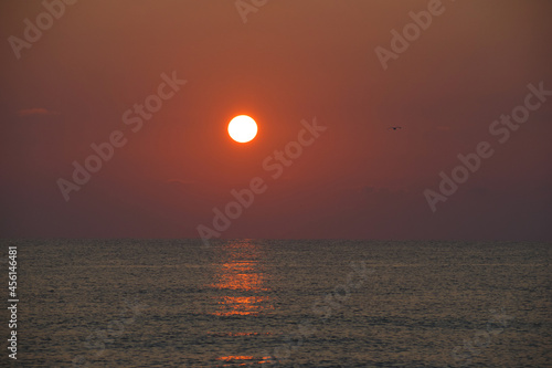 The sun above the sea. Sunrises and sunsets at sea, ocean. Travel and vacations - concept.