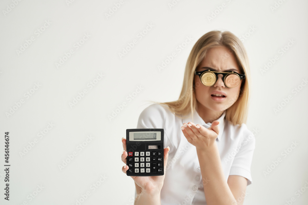 pretty woman calculator in hand and bitcoin light background pretty woman calculator in hand and bitcoin light background