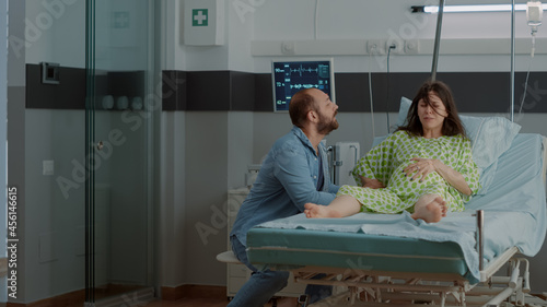 Photos Woman with pregnancy and painful contractions in hospital ward asking for help from doctor or nurse