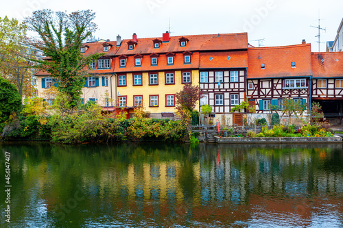 Houses situated at the Regnitz riverside in Bamberg . Coastal houses with attics in Bamberg Bavaria . Typical residential district in Germany 