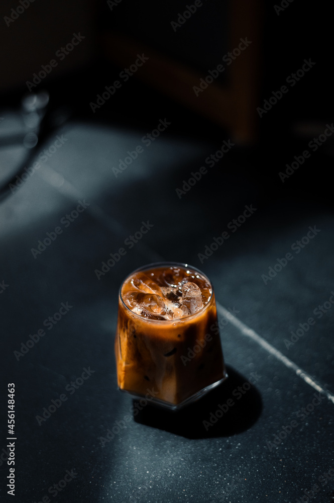 iced coffee served on black table at cafe​