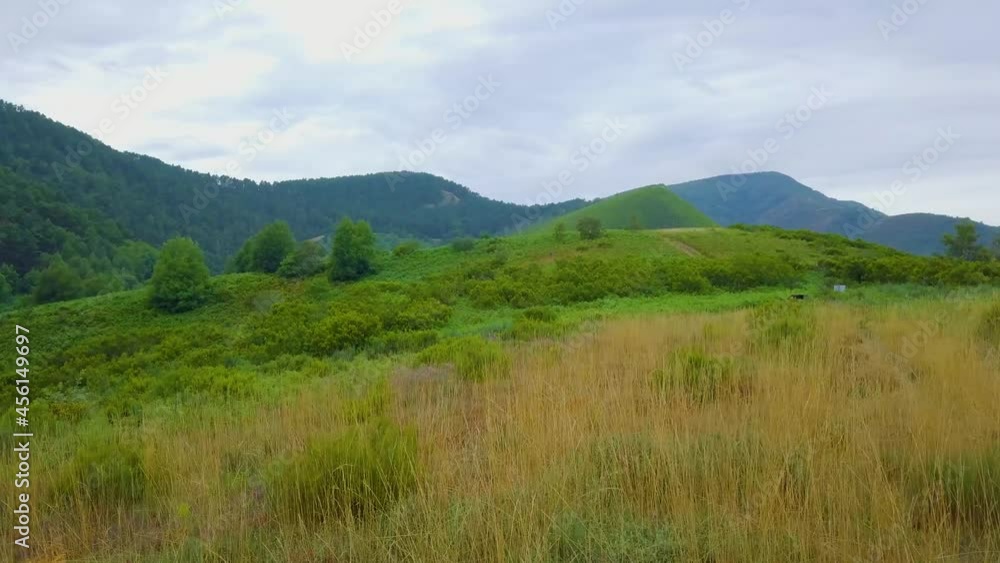 golden grass over green mountains golden grass over green mountains