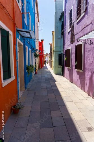 Typical colored houses of Burano  narrow street with sunny day