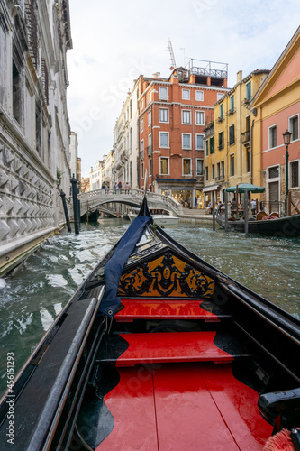 Gondola ride in Venice, the gondola passes over bridges and palaces