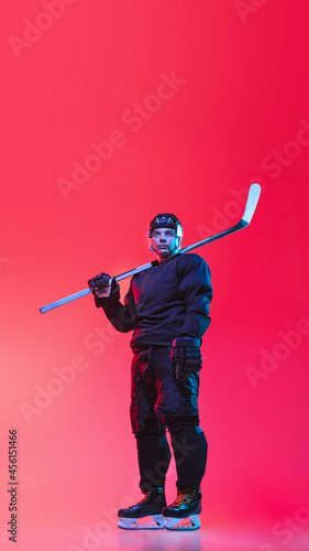 Photography Full-length image of professional hockey player in uniform with stick isolated o