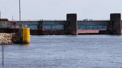 View of Lock and Dam No. 14 on Upper Mississippi River; on National Register of Historic Places;  Interstate 80 Bridge over Mississippi River in background; concepts of transportation and conservation photo