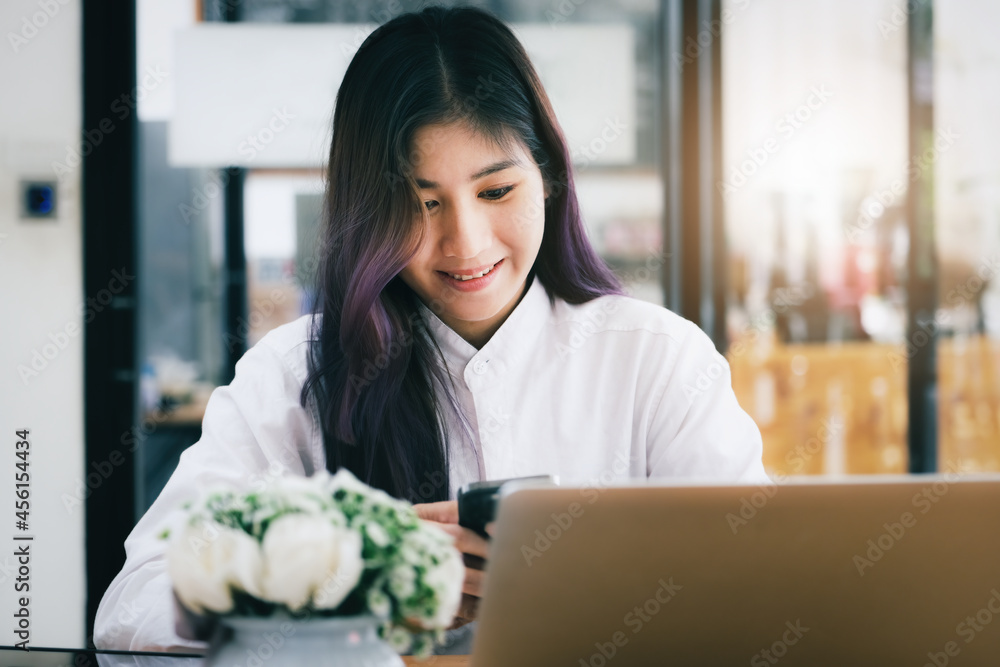 woman using mobile phone and computer to work in home office. woman using mobile phone and computer to work in home office.