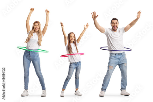 Family of a mother, father and daughter spinning hula hoops