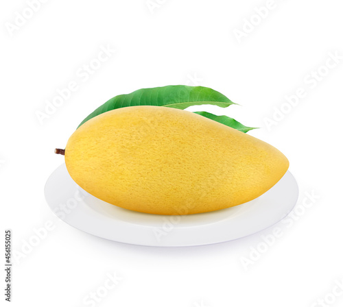 Golden yellow ripe mango fruit on plate isolated on white background