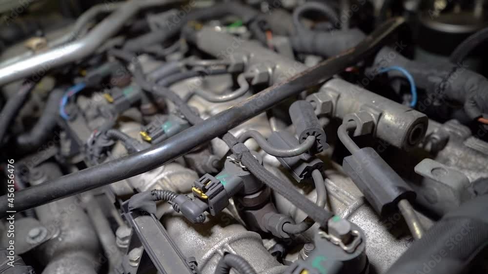 Close up view of old car engine under artificial lights. Diesel 5-valve motor starting. Macro shot of the inside of the car, engine from the vehicle is in car repair shop. Backward moving Close up view of old car engine under artificial lights. Diesel 5-valve motor starting. Macro shot of the inside of the car, engine from the vehicle is in car repair shop. Backward moving