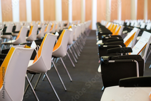 Chairs with bags in modern conference hall