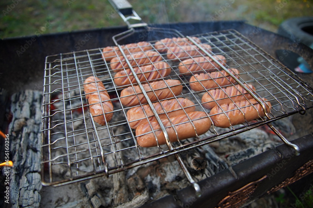 delicious fried sausages on the fire