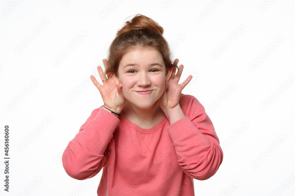 Close-up portrait of cheerful young girl making funny face. White background Close-up portrait of cheerful young girl making funny face. White background