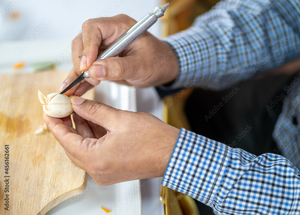 Chef carves patterns on cabbage and other vegetables and fruits for a beautiful table decoration Chef carves patterns on cabbage and other vegetables and fruits for a beautiful table decoration