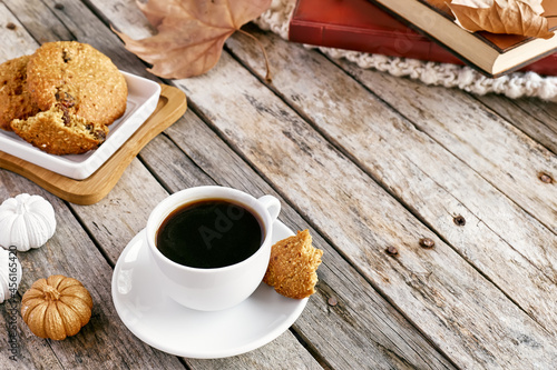 Morning coffee with dietetic crunchy gluten free biscuits on wooden table. Healthy eating. Vegan pumpkin cookies. Autumn vibes. Cozy breakfast.