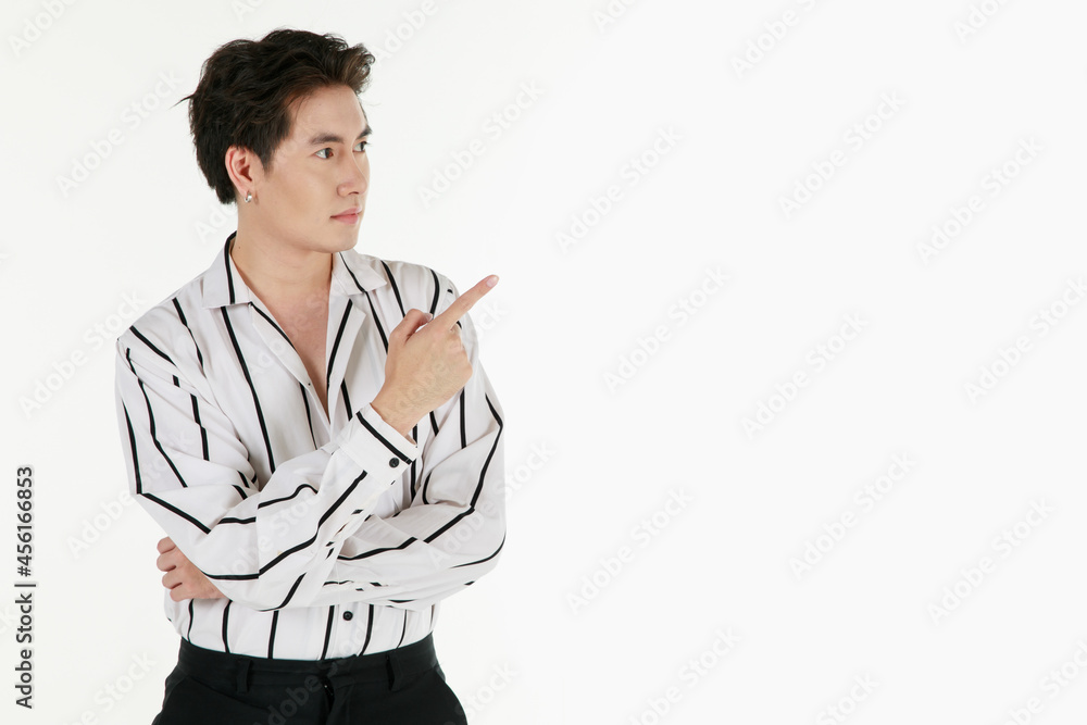 Portrait of self confidence young and handsome business Asian man with friendly and charming successful emotion pose against isolated on white background and pointing finger to blank space Portrait of self confidence young and handsome business Asian man with friendly and charming successful emotion pose against isolated on white background and pointing finger to blank space