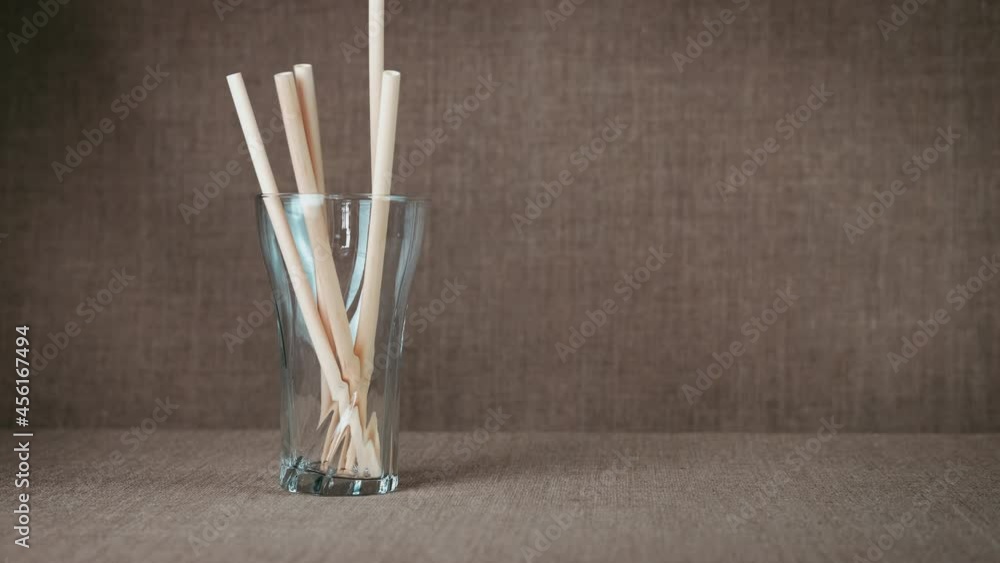 Eco-friendly drinking straw. A glass of reusable straws. Eco-friendly drinking straw. A glass of reusable straws.