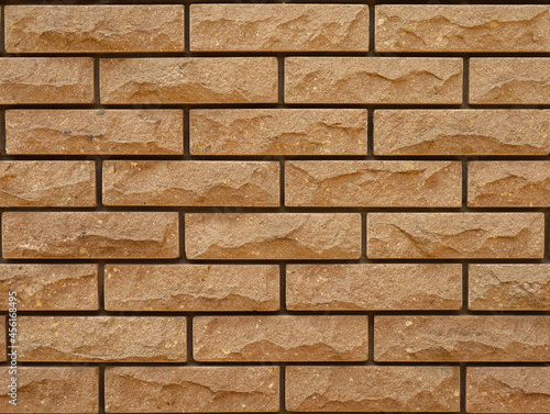 Yellow brick wall texture. Seamless background of brick