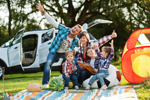 Family spending time together. Three kids. Outdoor picnic blanket. © AS Photo Family