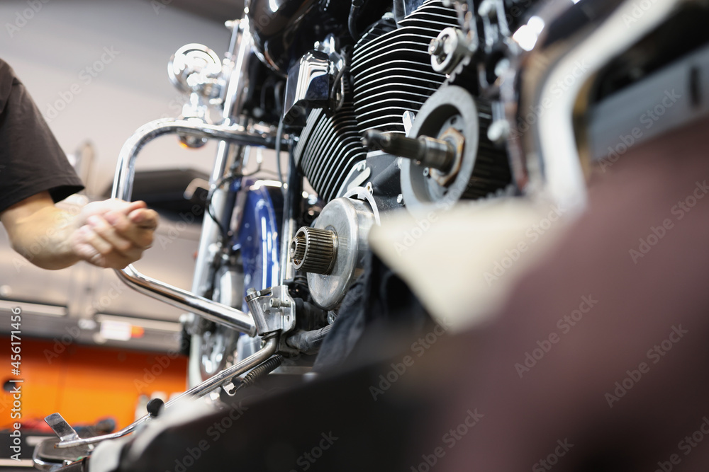 Fototapeta premium Repair and maintenance of motorcycle engines in car workshop closeup